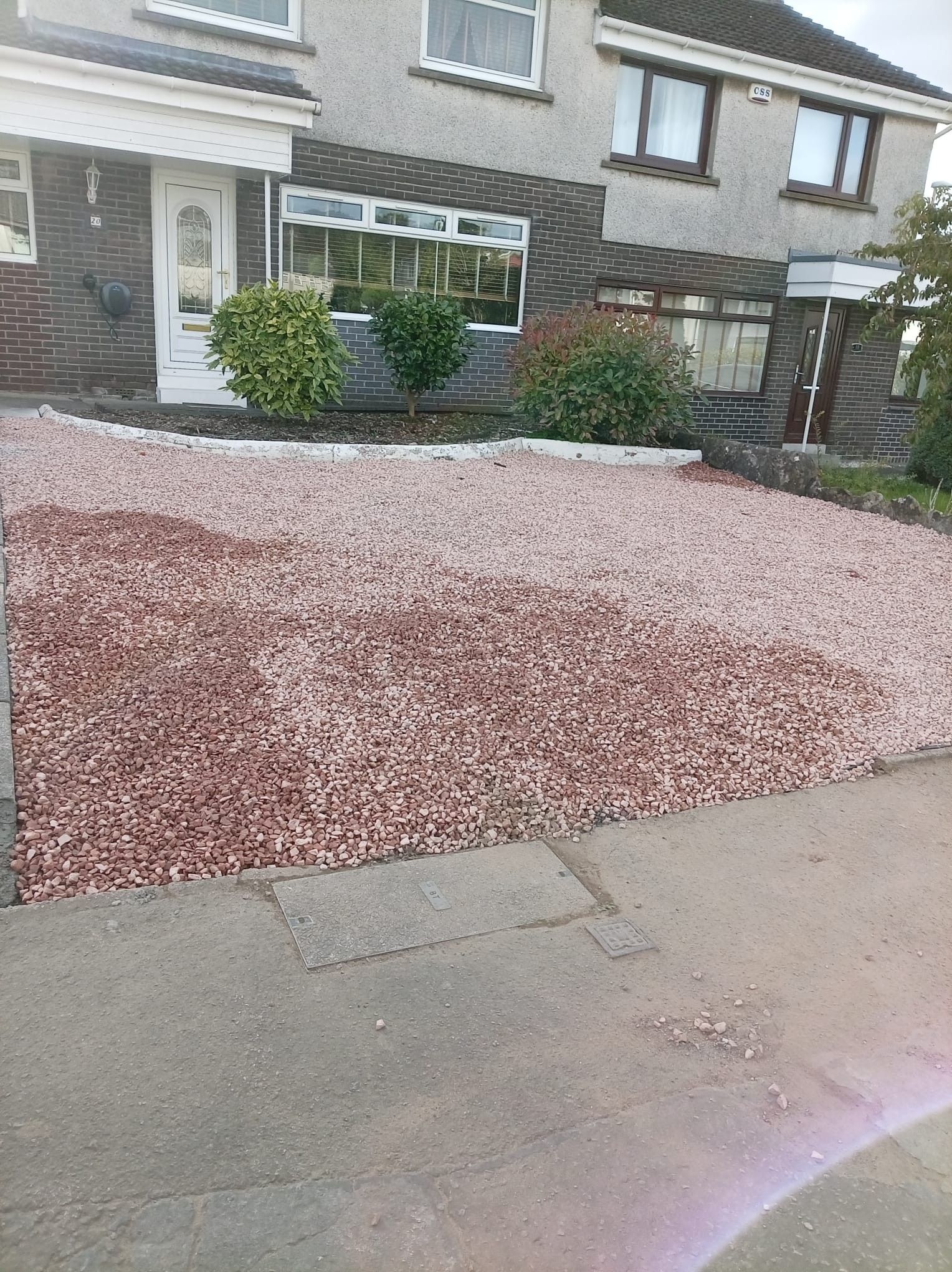 A front garden finished with fresh red decorative chips and a relaid slab path, from a recent job in Falkirk